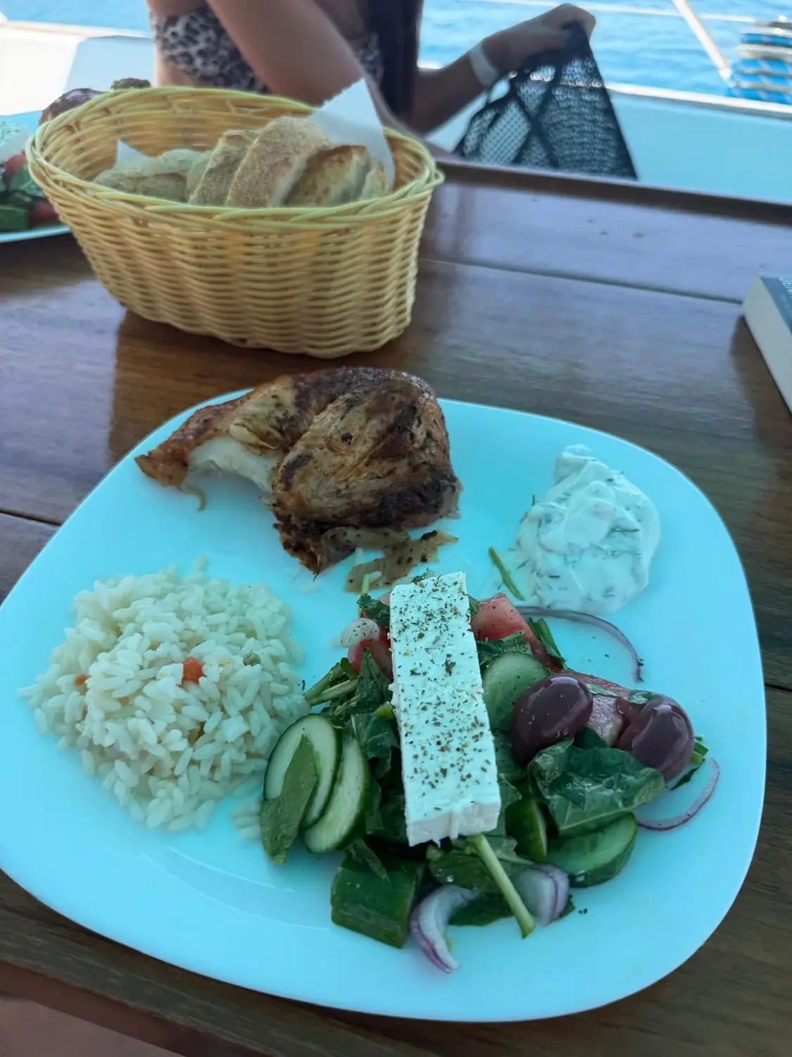 Roast chicken, rice and Greek salad freshly prepared on board